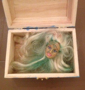 There was a decapitated Barbie head inside the box.